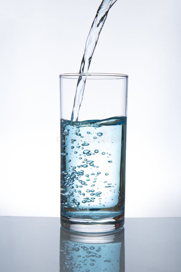 Pouring water into glass stock image Pouring water into glass stock image