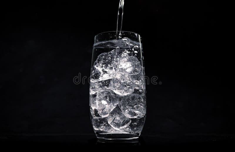 Water with Crushed Ice Cubes in Glass on White Background Stock Image