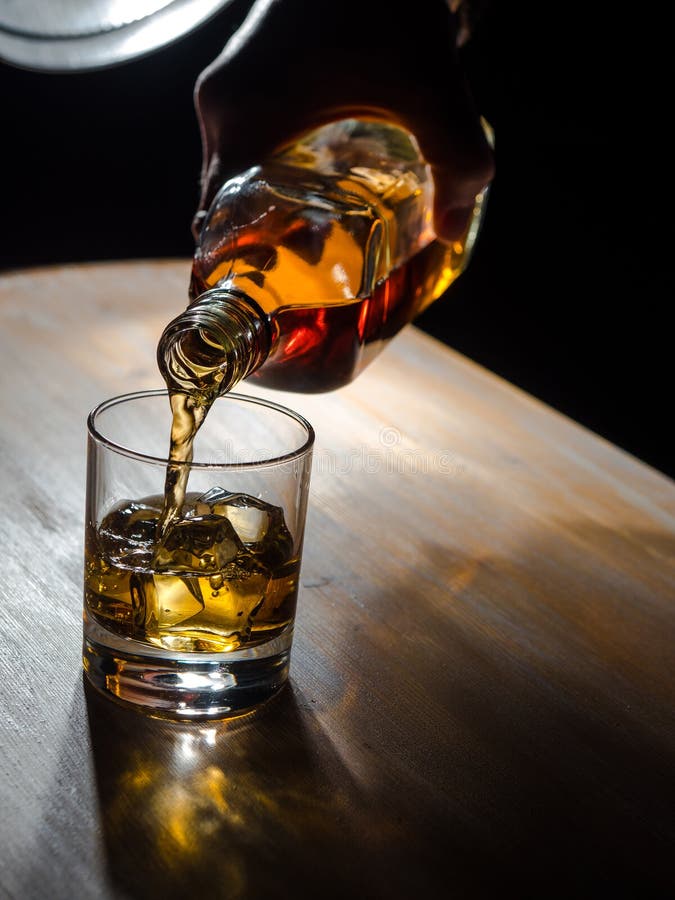 A Large Whiskey Poured Over Ice Cubes In A Plain Glass Stock Photo, Picture  and Royalty Free Image. Image 33810265.