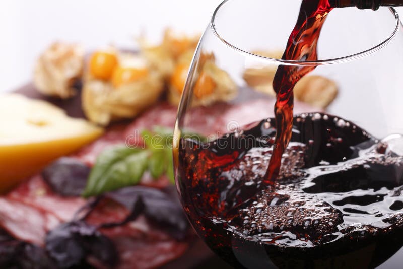 Pouring wine into glass and food