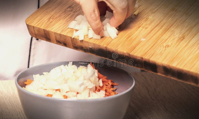 Pours crushed onions and carrots