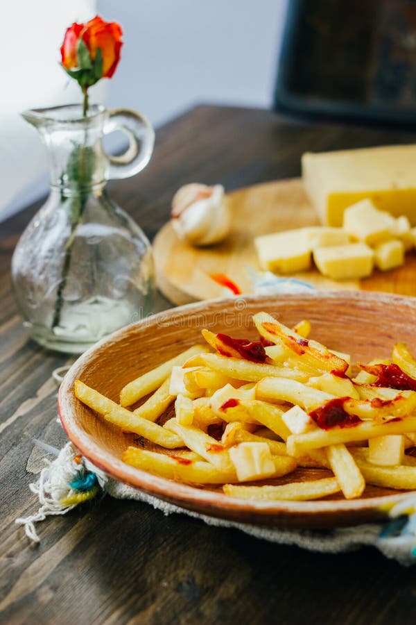 Poutine Fries On Black Surface. Canadian Dish With Potatoes, Cheese And