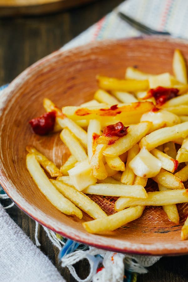 Poutine Fries on Black Surface. Canadian Dish with Potatoes, Cheese and ...