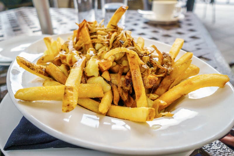 Poutine fries served on white plate stock photography Poutine fries served on white plate stock photography