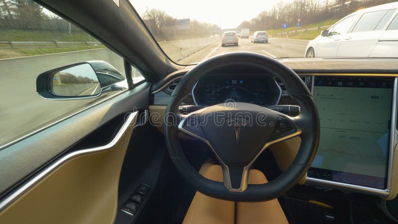 POV: Driving down a busy highway in a high tech self navigating Tesla car. royalty free stock photos