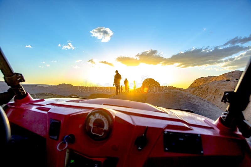 POV off-road vehicle into the sun with people and lens flare