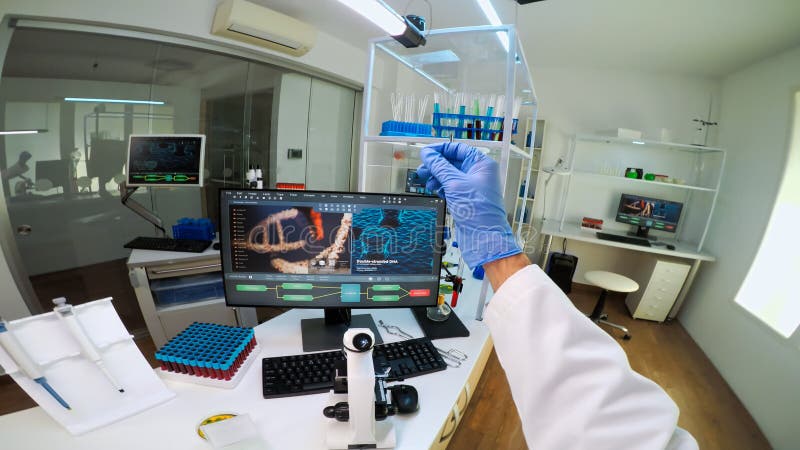 POV of scientist looking at biological samples under microscope stock image