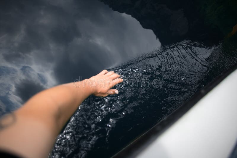POV of female hand touching water from inside boat stock photography POV of female hand touching water from inside boat stock photography