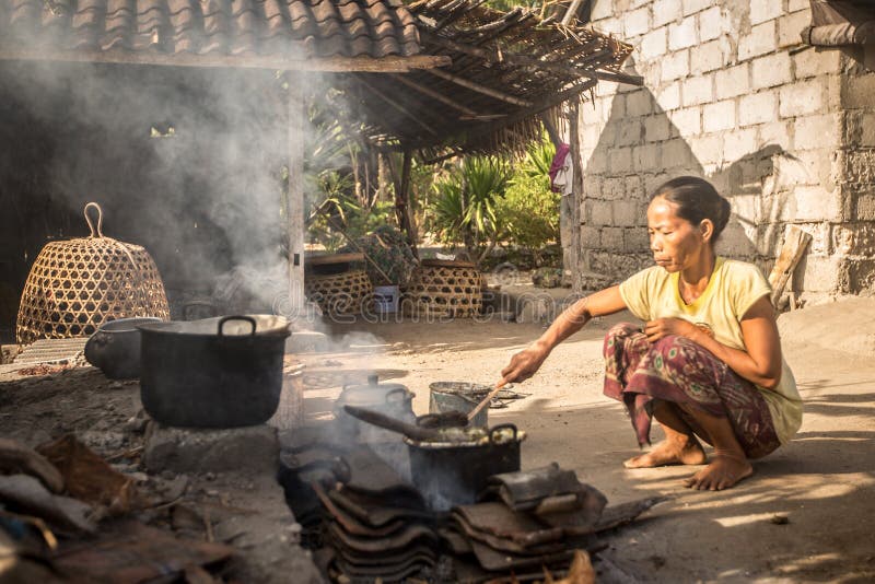 Poverty woman cooks meal using basic essentials stock photos Poverty woman cooks meal using basic essentials stock photos
