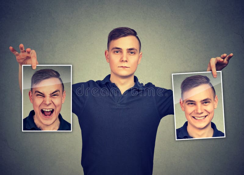 Serious young man holding two different face emotion masks of himself. Serious young man holding two different face emotion masks of himself
