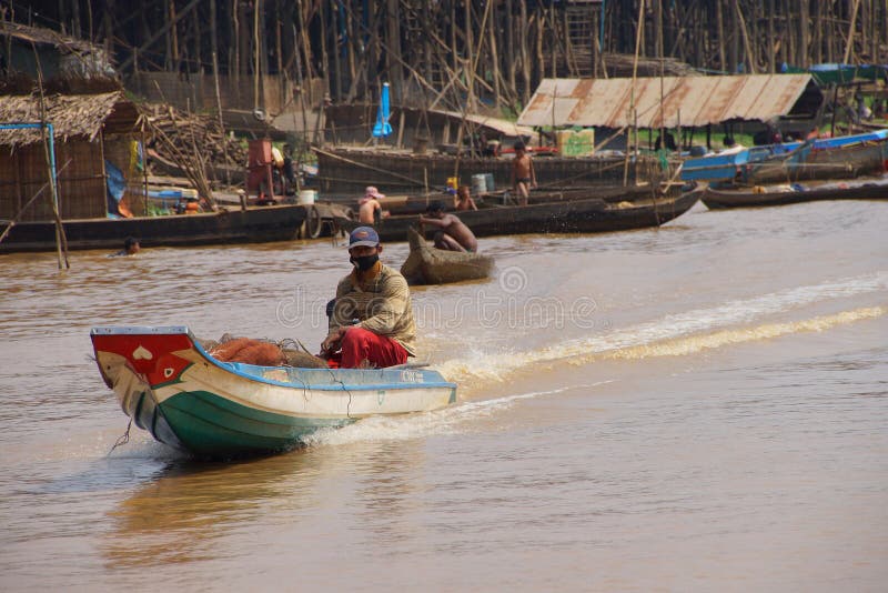 Power boat travels waterway. KOMPONG KLEANG, CAMBODIA - FEB 12, 2015 - Power boat travels along the waterway of Kompong Kleang floating fishing village, Cambodia royalty free stock images Power boat travels waterway. KOMPONG KLEANG, CAMBODIA - FEB 12, 2015 - Power boat travels along the waterway of Kompong Kleang floating fishing village, Cambodia royalty free stock images