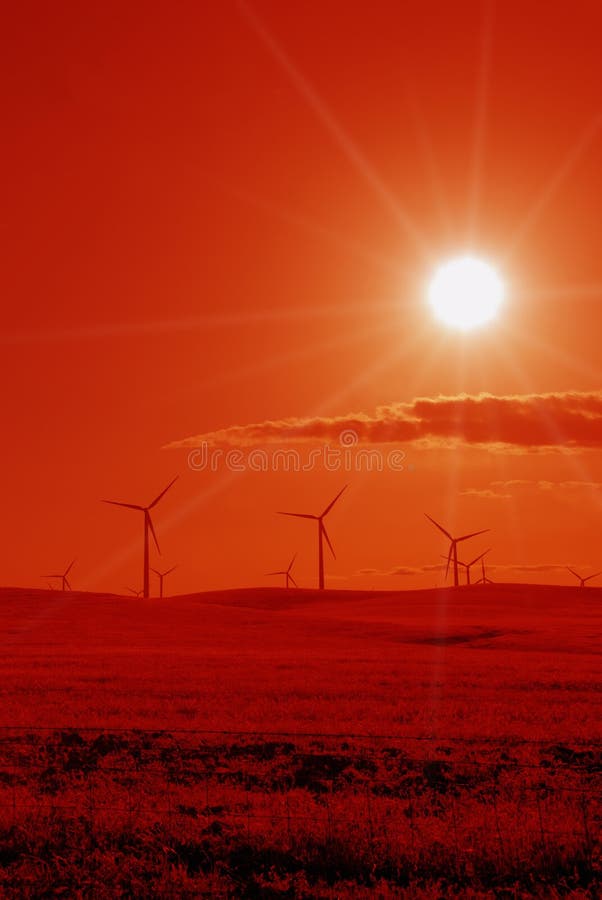 Power Generating Wind Turbines in Stylized Red Against Blazing Sun