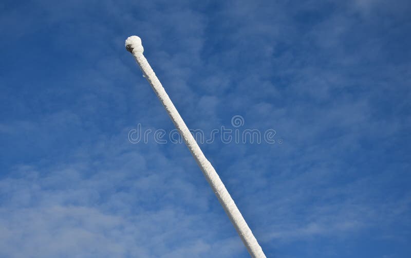 Power lines frozen by a large layer of ice layer in the shape of a cylinder with icicles. icing burdens the poles, ladder and ligh royalty free stock images