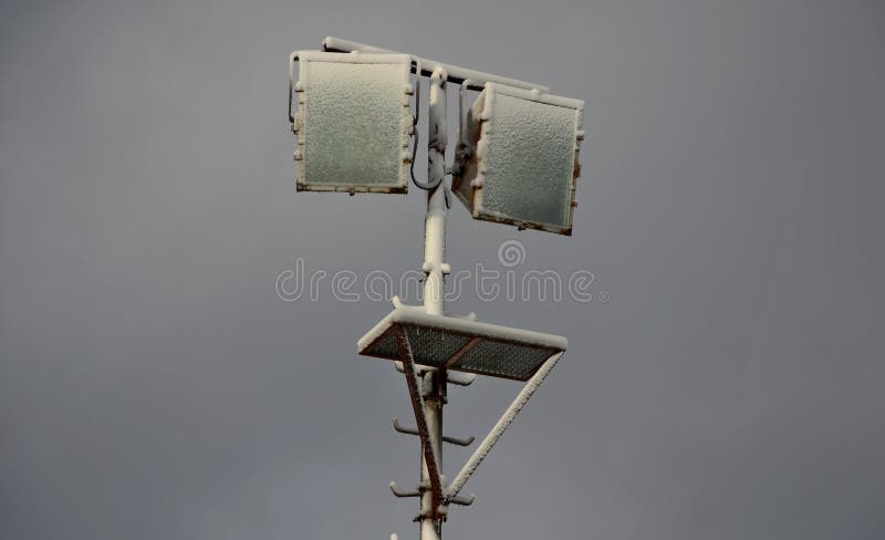 Power lines frozen by a large layer of ice layer in the shape of a cylinder with icicles. icing burdens the poles, ladder and ligh royalty free stock photos