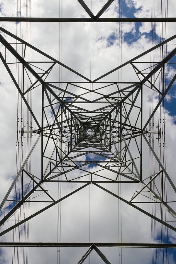 Power lines run vertically through this abstract image of a pylon. Abstract background texture image of power transmission lines running behind the metal lattice frame work of an electrical transmission tower