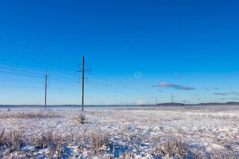 Power lines in winter snow field