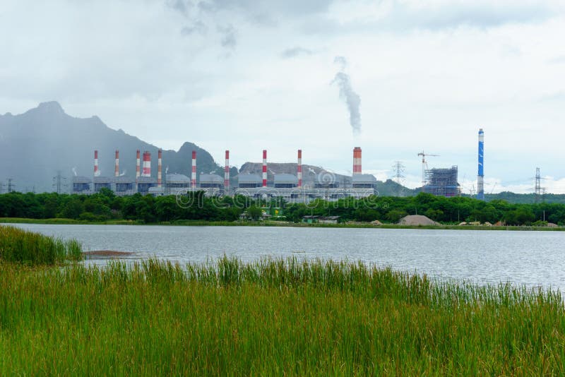 Power plan near pond among the tree and grass. Mae moh power plant generating electricity for thai people royalty free stock photo Power plan near pond among the tree and grass. Mae moh power plant generating electricity for thai people royalty free stock photo