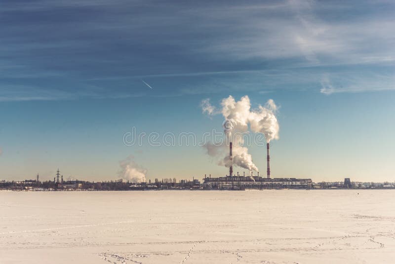 Power plant, Energy power station area on frozen river or lake at blue sky