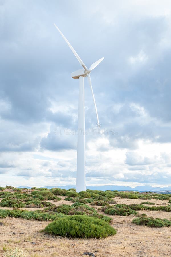Power plant with wind turbines in open field background stock images