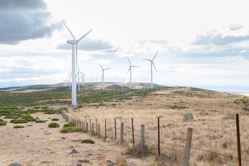Power plant with wind turbines in open field background royalty free stock photos