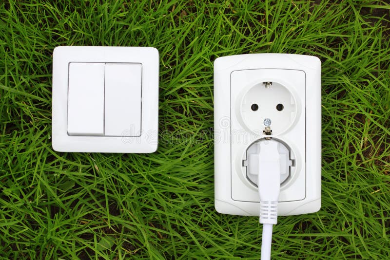 Power receptacle and light switch on a green grass