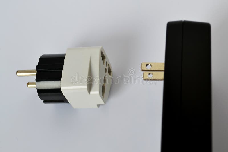 Power supply unit or buttery charger for an electrical network with a voltage of 110 volts and a 220 volt adapter on a white backg stock photo