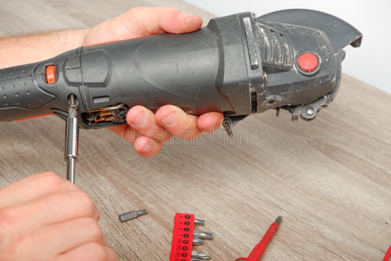 Power Tool Repair. an Engineer Repairing an Angle Grinder. Assembling