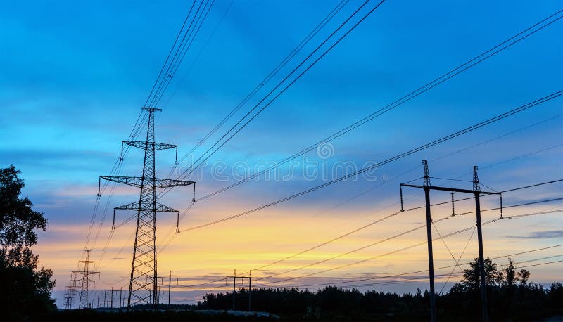 Power transmission tower silhouetted against the sunset glow.