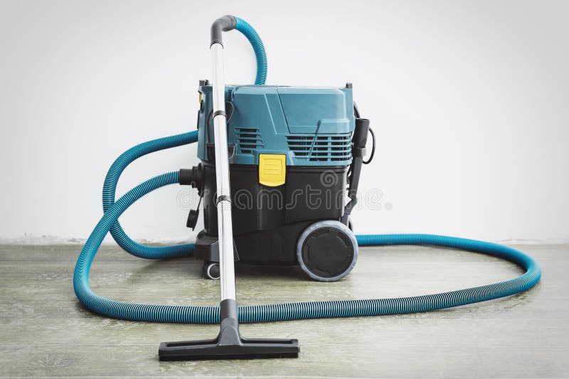 Powerful Construction Vacuum Cleaner in an Empty Room after Renovation