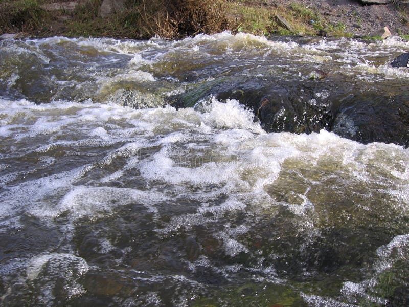 A powerful, raging torrent of water in the river the spring flood foam on the waves