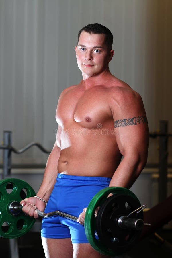 Powerlifter with barbell in gym