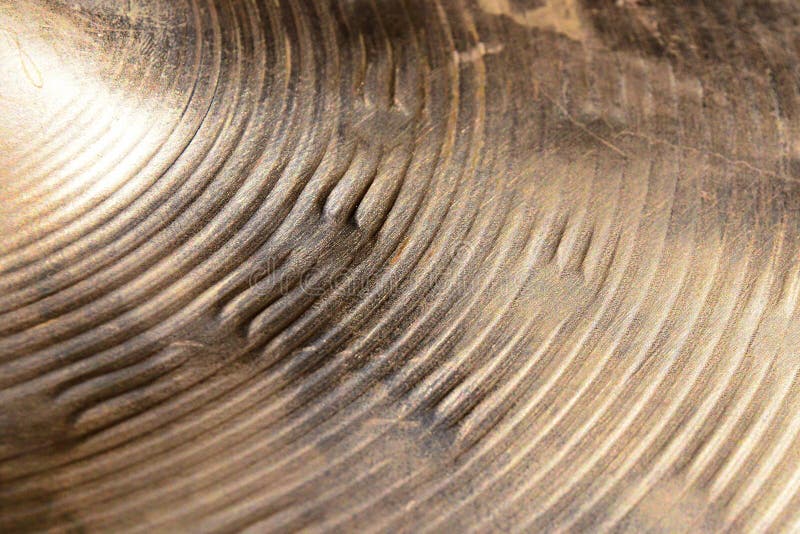 Surface of heavily used hihat bronze hand hammered cymbal on direct sunlight. Surface of heavily used hihat bronze hand hammered cymbal on direct sunlight.