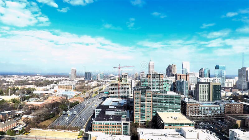 An ultra wide aerial landscape photo of Midtown Atlanta, Georgia with a blue sky with large clouds. An ultra wide aerial landscape photo of Midtown Atlanta, Georgia with a blue sky with large clouds.