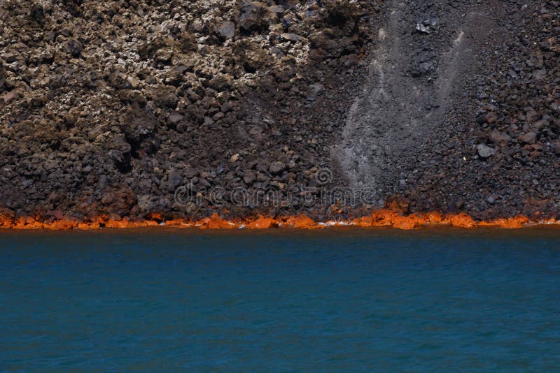 Scenic view of sulfurous lava burning in sea, Santorini volcano, Greece. Scenic view of sulfurous lava burning in sea, Santorini volcano, Greece.