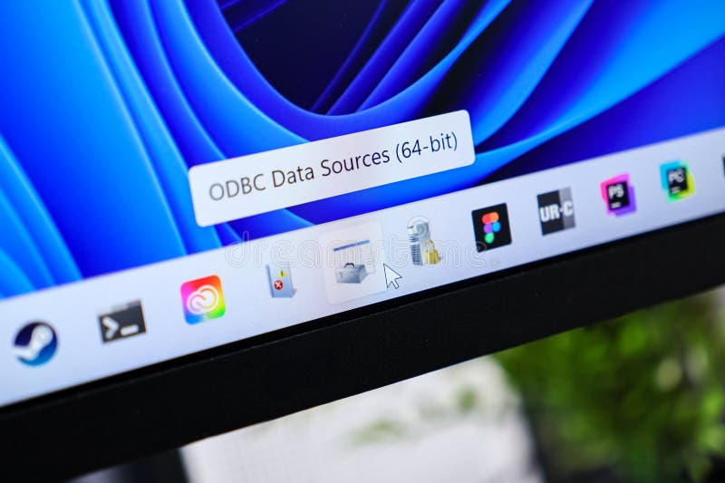 Poznan, Poland - June 6, 2025: A detailed view shows the ODBC Data Sources 64-bit tooltip on a computer monitor, depicting Windows 11 taskbar icons and IT management.