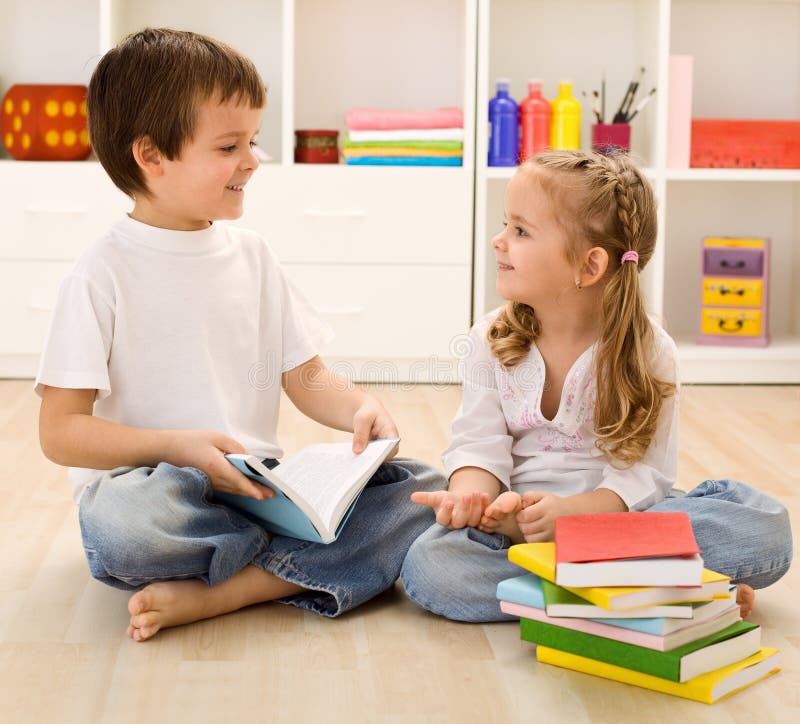 Let me tell you about school - siblings with books talking at home, back to school concept. Let me tell you about school - siblings with books talking at home, back to school concept