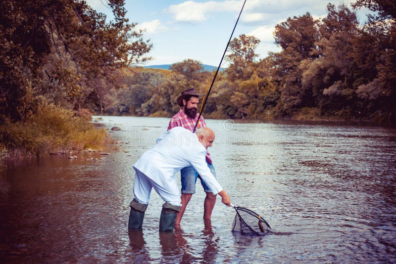 Weekend fishing. Real happiness. Handsome men and father relax. Man fisherman catches a fish. Bearded men and elegant businessman fishing together. Just do that only. Legend has retired. Weekend fishing. Real happiness. Handsome men and father relax. Man fisherman catches a fish. Bearded men and elegant businessman fishing together. Just do that only. Legend has retired