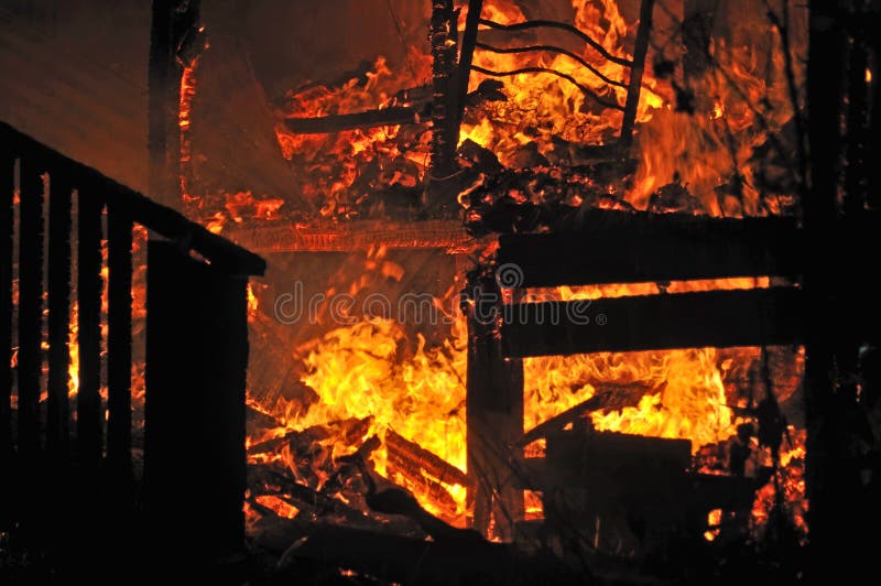 Stairs and bedroom furniture silhouetted in house fire. Stairs and bedroom furniture silhouetted in house fire