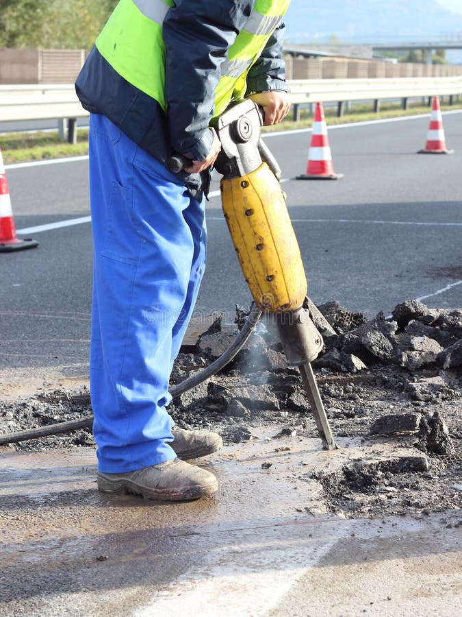 Road repairing works with jackhammer. Road repairing works with jackhammer