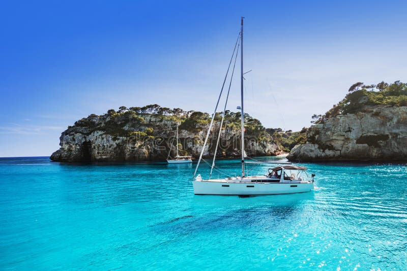 Prachtig strand met zeilboot jacht cala macarelleta menorca eiland spanje. jachthaven en actief lifestyle - concept