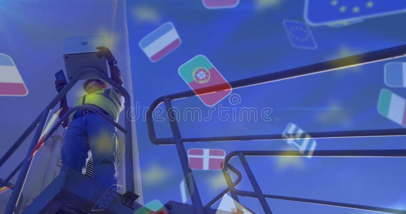 Pracownicy zajmujący się mocowaniem dźwigów nad wizerunkiem flag Unii Europejskiej zdjęcia stock