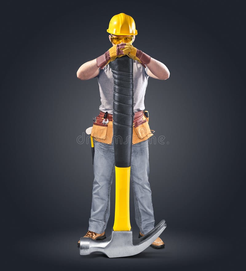 Construction worker in helmet with tool and hammer on a black background. Construction worker in helmet with tool and hammer on a black background