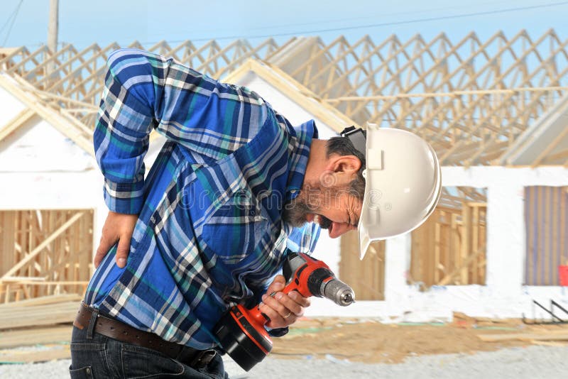 Hispanic worker getting back injury on construction site. Hispanic worker getting back injury on construction site