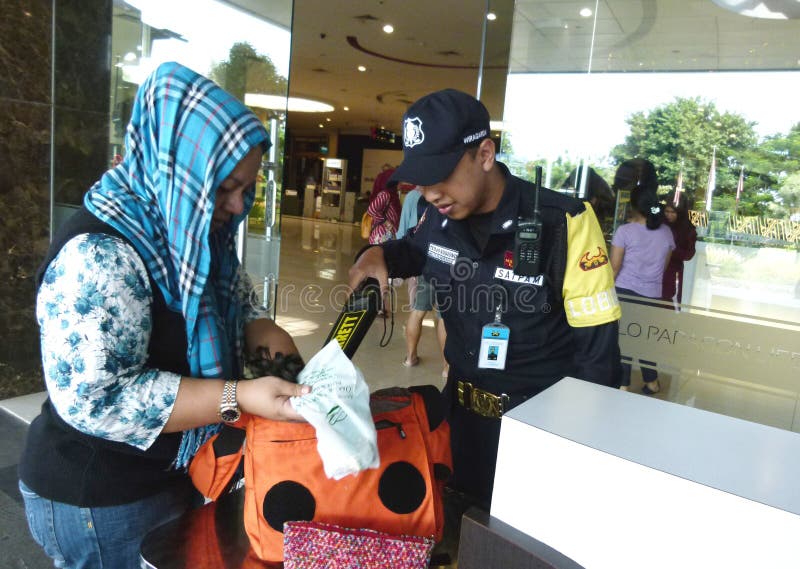 Mall security guards checking visitors in order to prevent acts of terrorism in the city of Solo, Central Java, Indonesia. Mall security guards checking visitors in order to prevent acts of terrorism in the city of Solo, Central Java, Indonesia