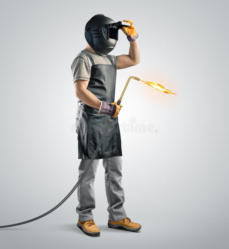 Worker welder in a protective mask with gas welding machine on isolated backgroundr. Worker welder in a protective mask with gas welding machine on isolated backgroundr