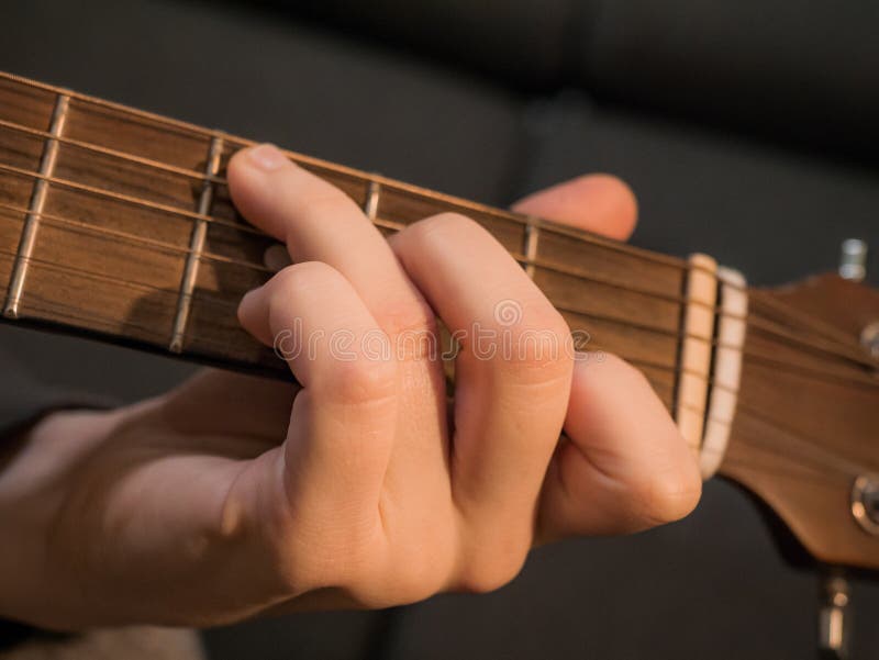 Practice Playing the Acoustic Guitar. Hands Playing Guitar and Picking Chords Stock Photo