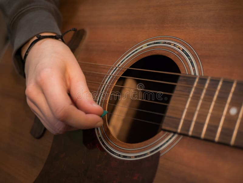 Practice Playing the Acoustic Guitar. Hands Playing Guitar and Picking Chords Stock Photo