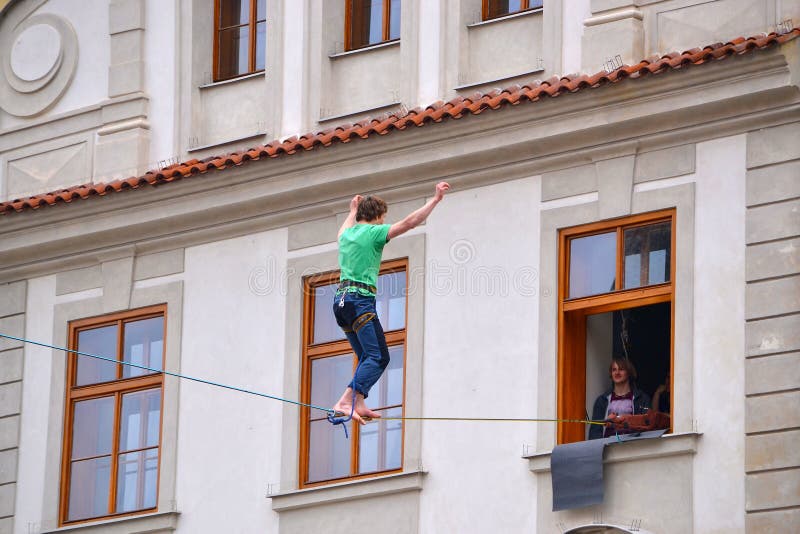 Slackline above Prague`s Old Town Square, between the Astronomical Clock and the opposite building