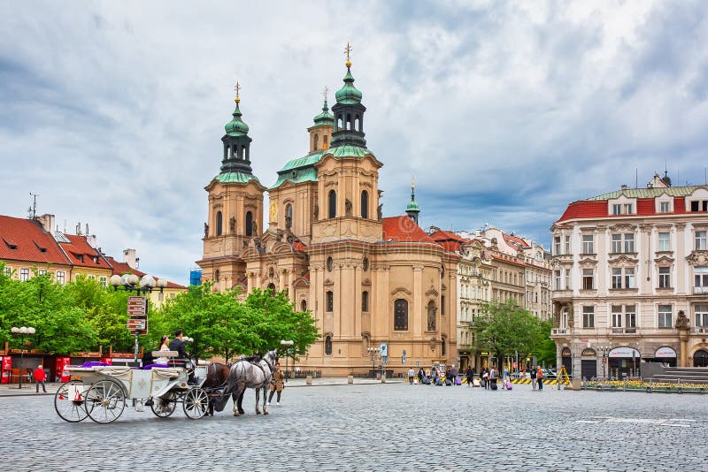 PRAGUE, CZECH REPUBLIC - April 26th, 2018: Horse cart in the Old Town Square, St Nicholias `s Church