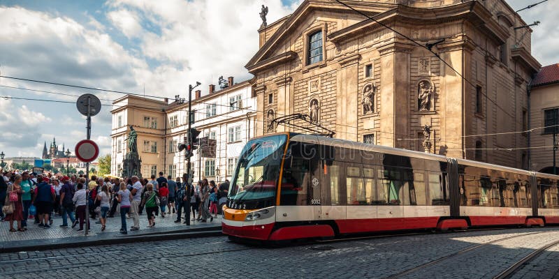 PRAGUE, CZECH REPUBLIC - Aug. 23, 2019: Busy street in the old part of Prague near the Royal Bridge with a modern tram and royalty free stock images PRAGUE, CZECH REPUBLIC - Aug. 23, 2019: Busy street in the old part of Prague near the Royal Bridge with a modern tram and royalty free stock images